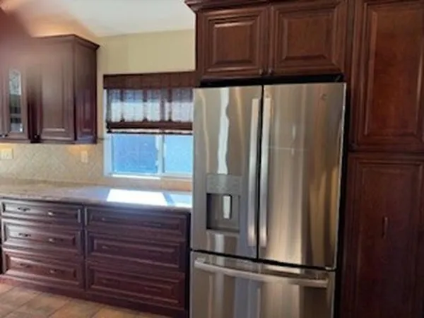 a kitchen with cabinets and stainless steel appliances