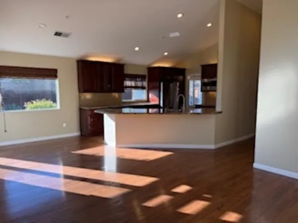 a kitchen with stainless steel appliances granite countertop a refrigerator and a stove top oven