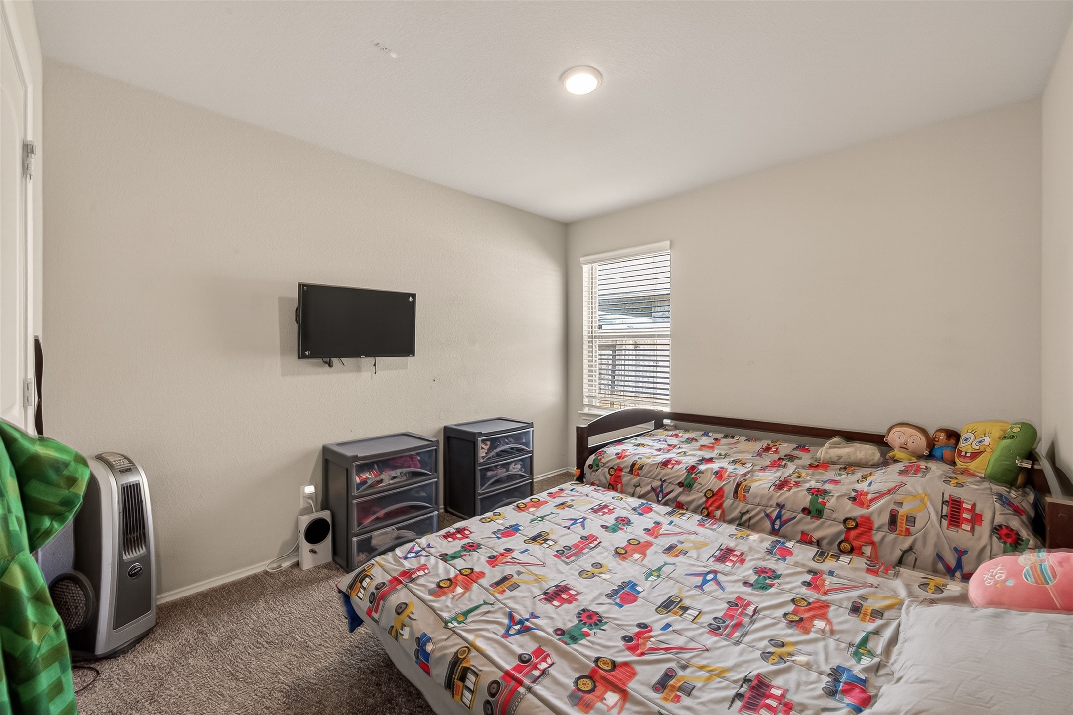 2407 Hartsel Frst Trail Spring, TX 77373 - Photo 16 of 26 a bedroom with a bed and a flat screen tv