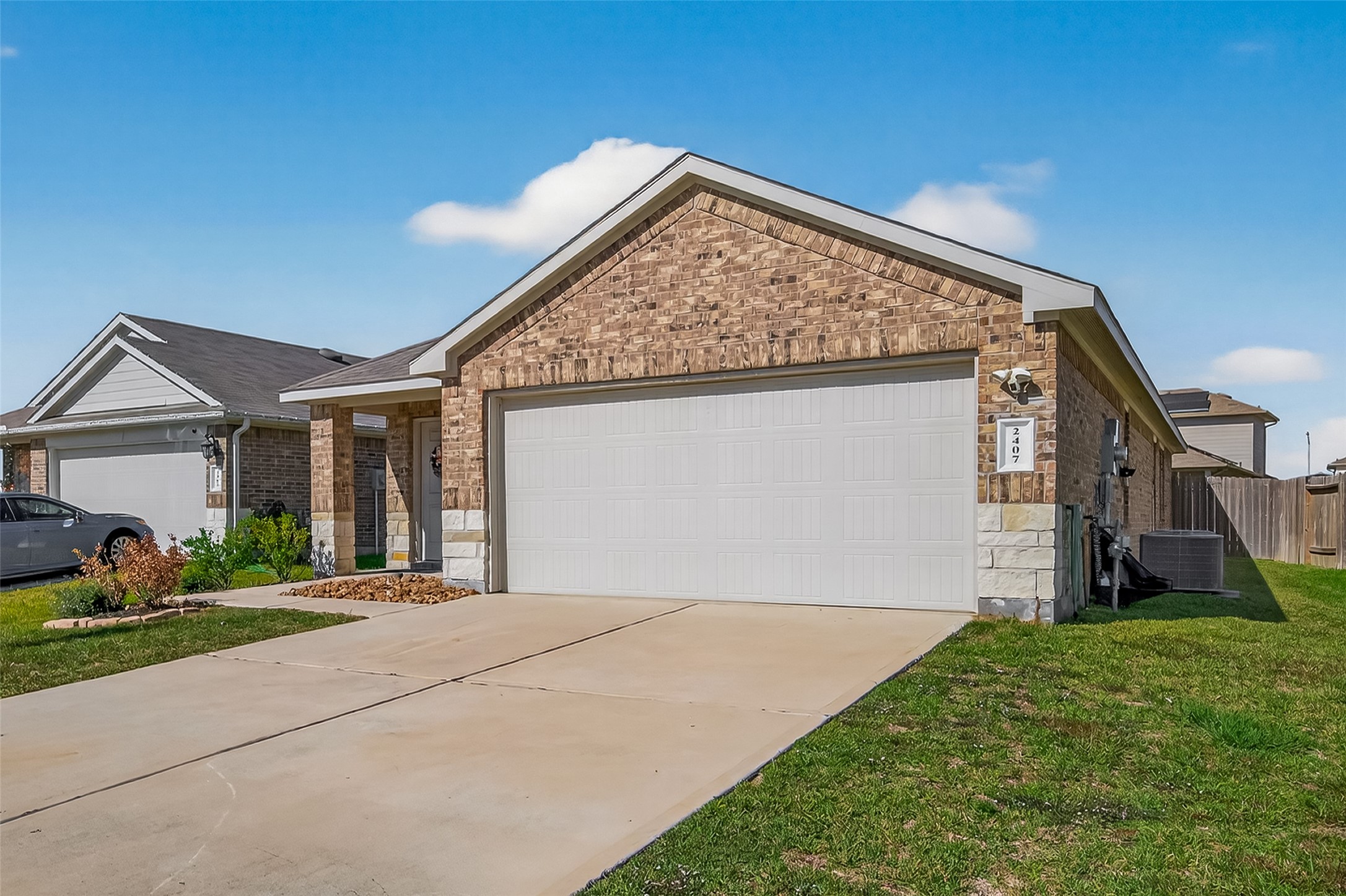 2407 Hartsel Frst Trail Spring, TX 77373 - Photo 2 of 26 a view of a house with a small yard and a large window