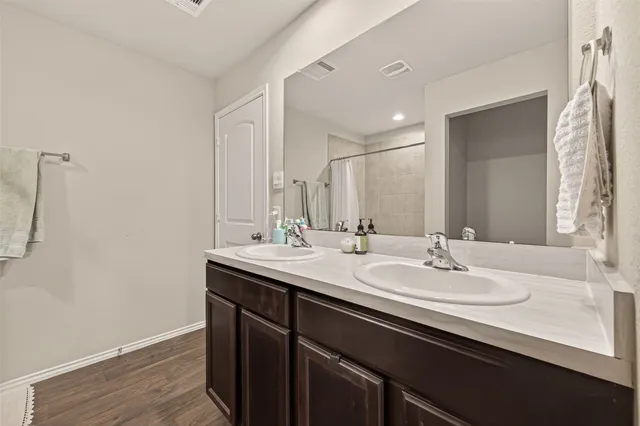 a bathroom with a sink double vanity and a mirror