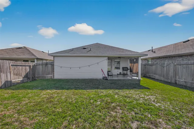a view of a backyard with a garden and entertaining space