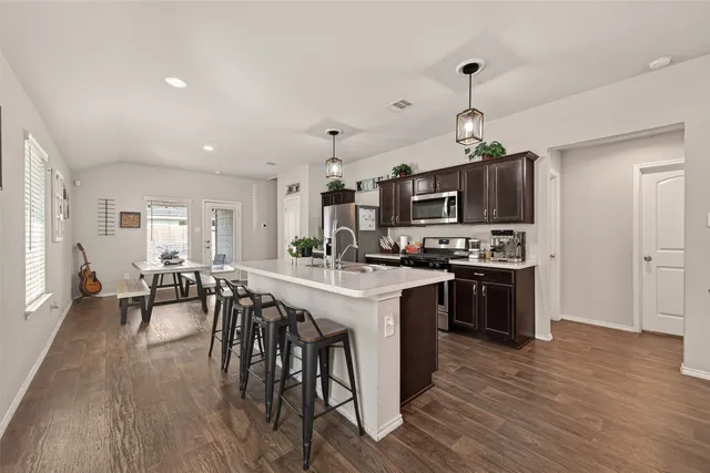 a large kitchen with a table and chairs