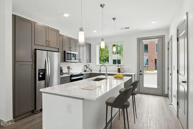 a kitchen with granite countertop a sink and stove