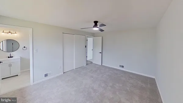 a view of an empty room and a bathroom
