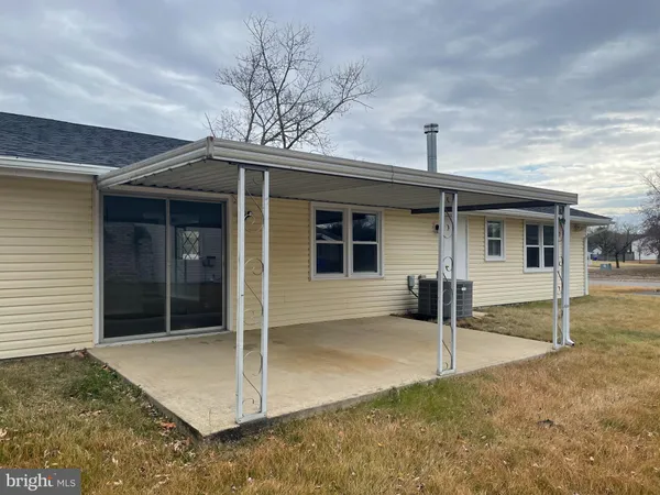 a view of a house with a door and wooden fence
