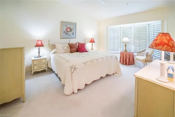 a spacious bedroom with a bed and a couch