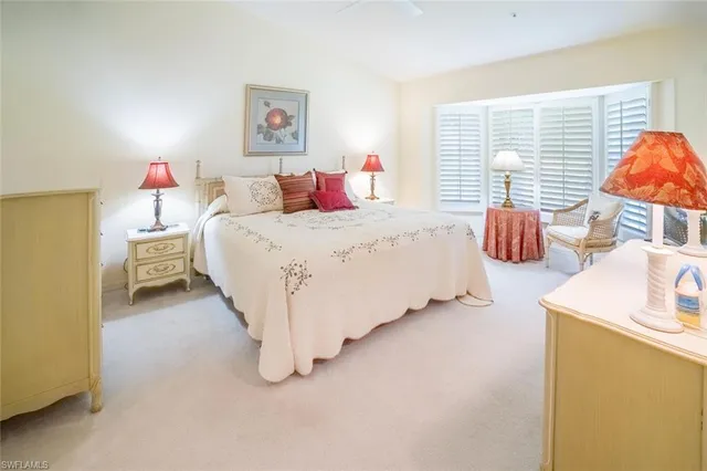 a spacious bedroom with a bed and a couch