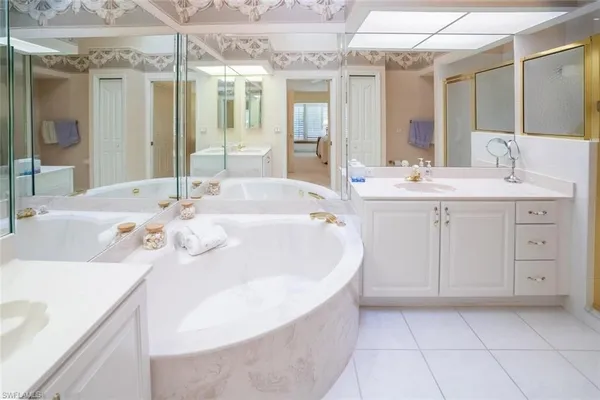 a spacious bathroom with a sink a mirror and a bathtub