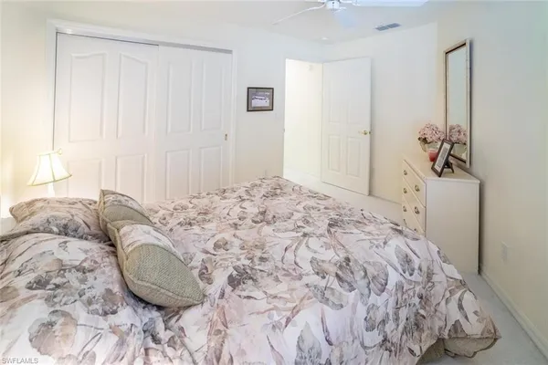 a bed sitting in a bedroom and painting on the wall