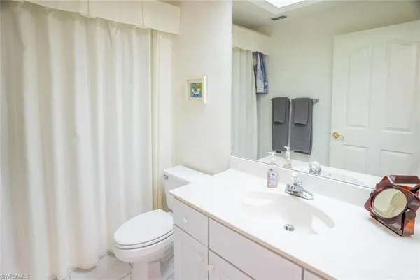 a bathroom with a sink toilet and a mirror
