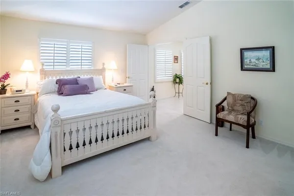 a bedroom with a bed window and a couch