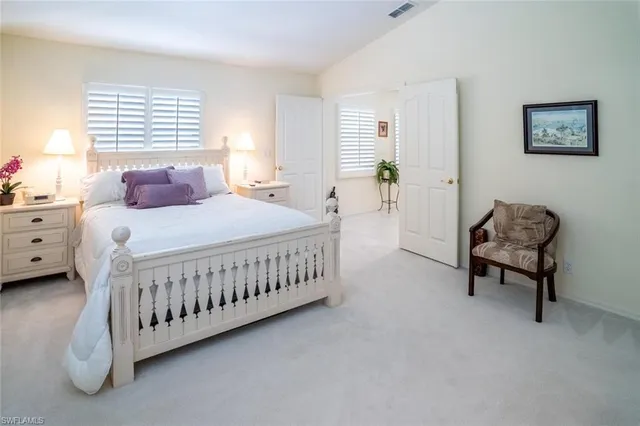 a bedroom with a bed window and a couch