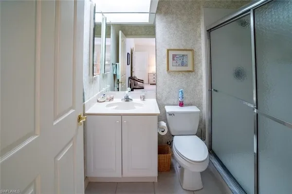 a bathroom with a sink mirror vanity and toilet
