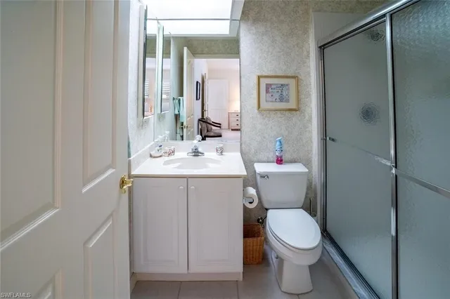 a bathroom with a sink mirror vanity and toilet