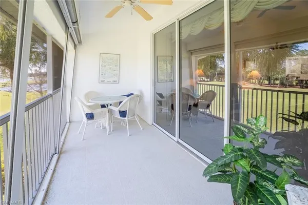 a dining room with furniture and a potted plant