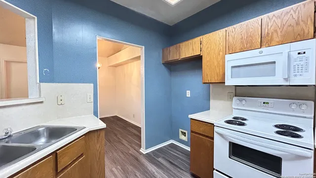 a kitchen with a sink stove and cabinets