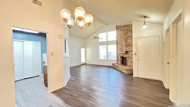 a view of livingroom with hallway and wooden floor