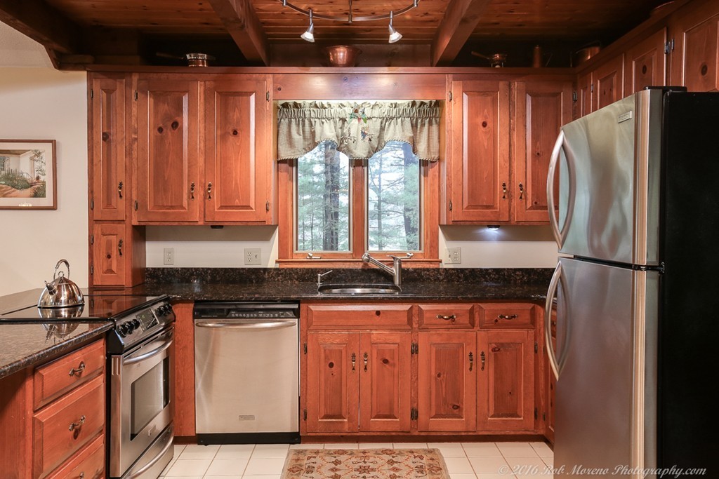68 B Rowley Road Boxford, MA 01921 - Photo 7 of 30 a kitchen with granite countertop a refrigerator and a sink