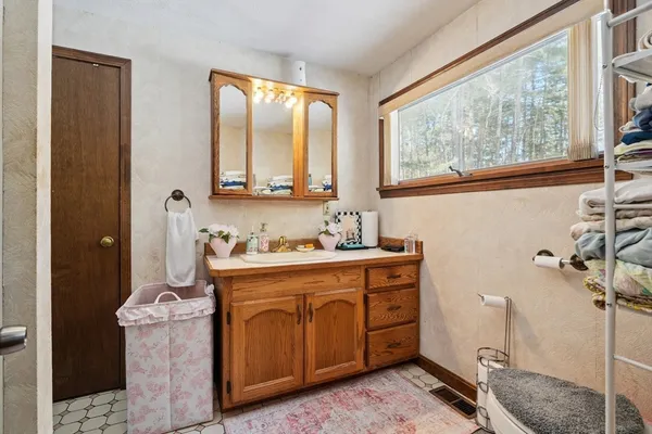 a spacious bathroom with a granite countertop sink and a mirror