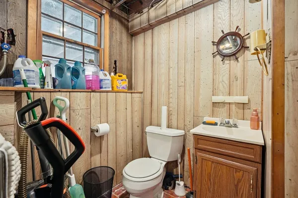 a bathroom with a toilet a sink and a shower curtain