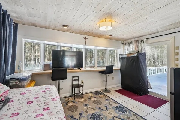 a very nice looking bedroom with a bed window and a flat screen tv