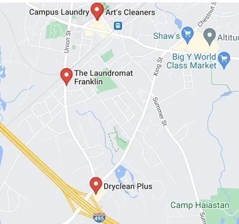 a sign that is sitting next to a white wall