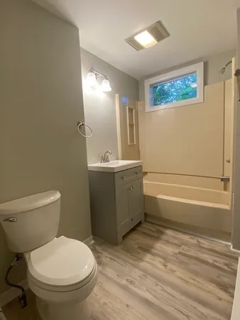 a bathroom with a toilet a sink and bathtub