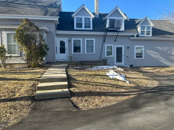 a view of a house with a bed and a yard