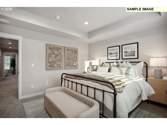 a bedroom with a bed a mirror and a large window