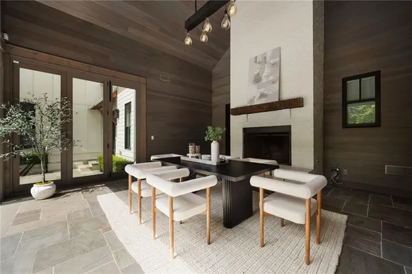 a kitchen with a table chairs and white cabinets