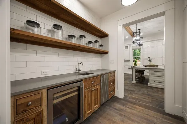 a spacious bathroom with a double vanity sink a mirror and a shower
