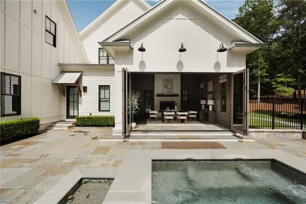 a view of a swimming pool with a patio and backyard