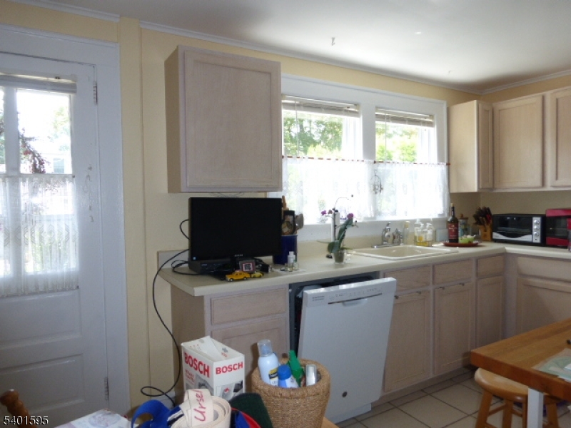18 Sherman Avenue, Unit B Morris Plains, NJ 07950 - Photo 11 of 24 a kitchen with a sink cabinets and window