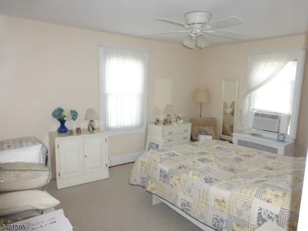 a bedroom with a white bed and a chandelier
