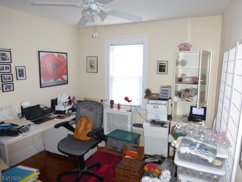 18 Sherman Avenue, Unit B Morris Plains, NJ 07950 - Photo 17 of 24 a living room with furniture and a chandelier
