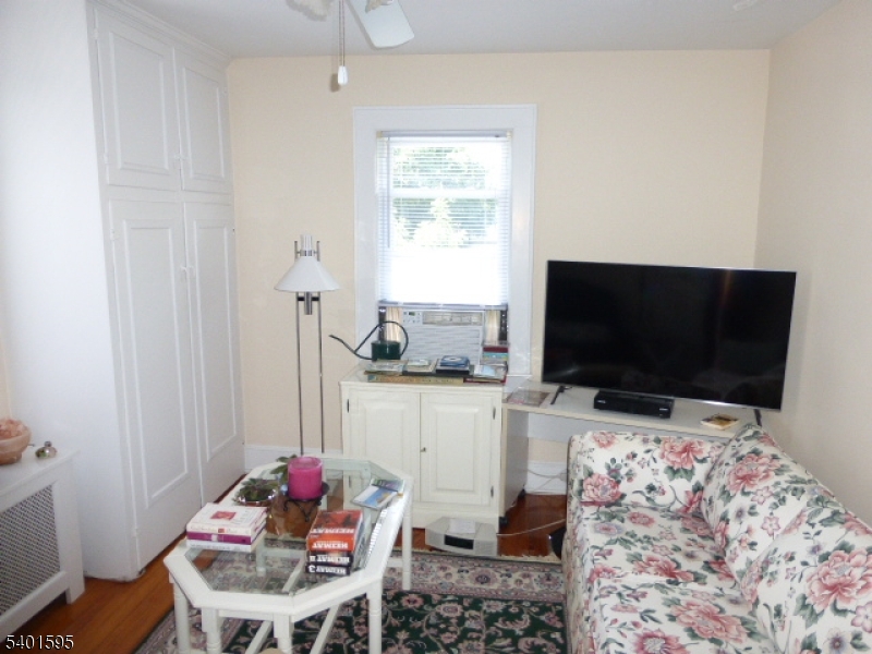 18 Sherman Avenue, Unit B Morris Plains, NJ 07950 - Photo 19 of 24 a living room with furniture and a flat screen tv