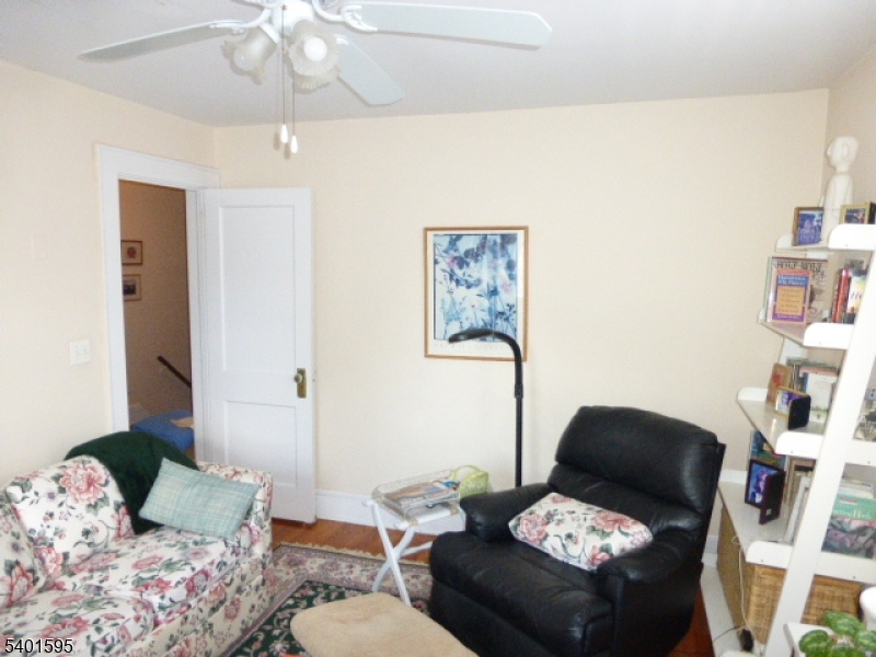 18 Sherman Avenue, Unit B Morris Plains, NJ 07950 - Photo 20 of 24 a living room with furniture and a chandelier