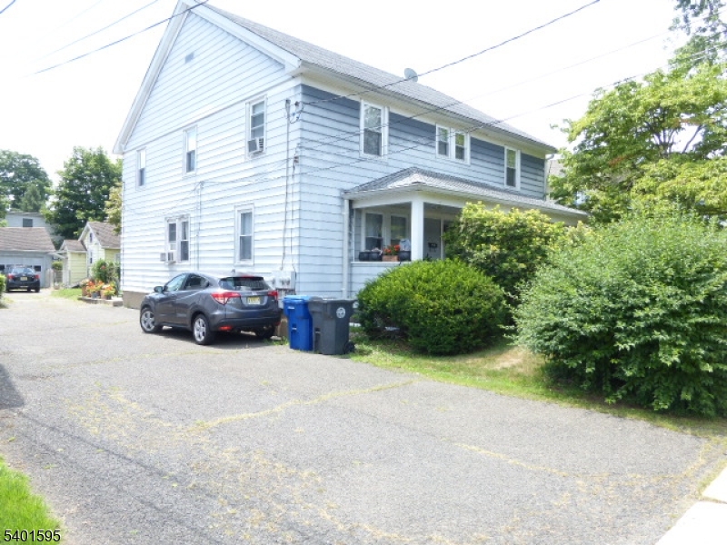 18 Sherman Avenue, Unit B Morris Plains, NJ 07950 - Photo 22 of 24 a view of a car parked in front of a white house