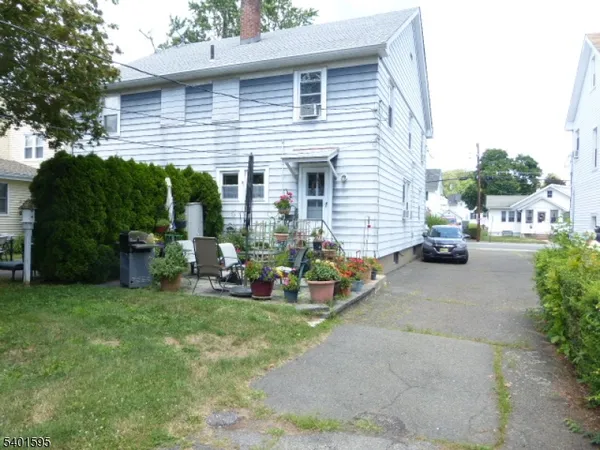a view of a house with backyard sitting area and garden