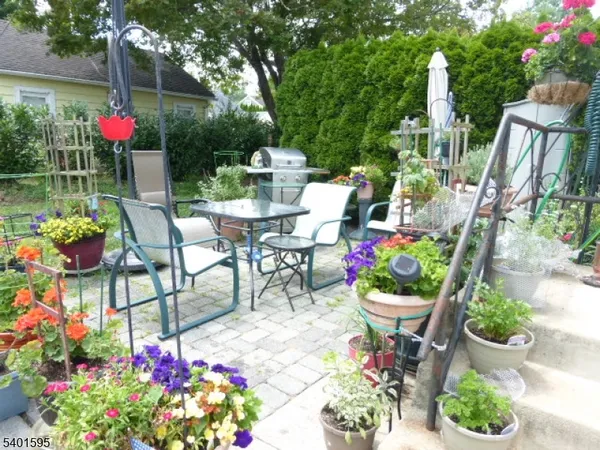 a front view of a house with yard and outdoor seating