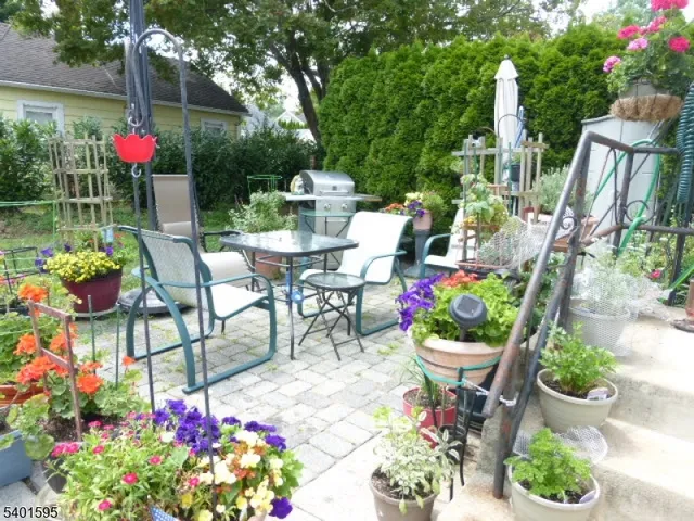 a front view of a house with yard and outdoor seating