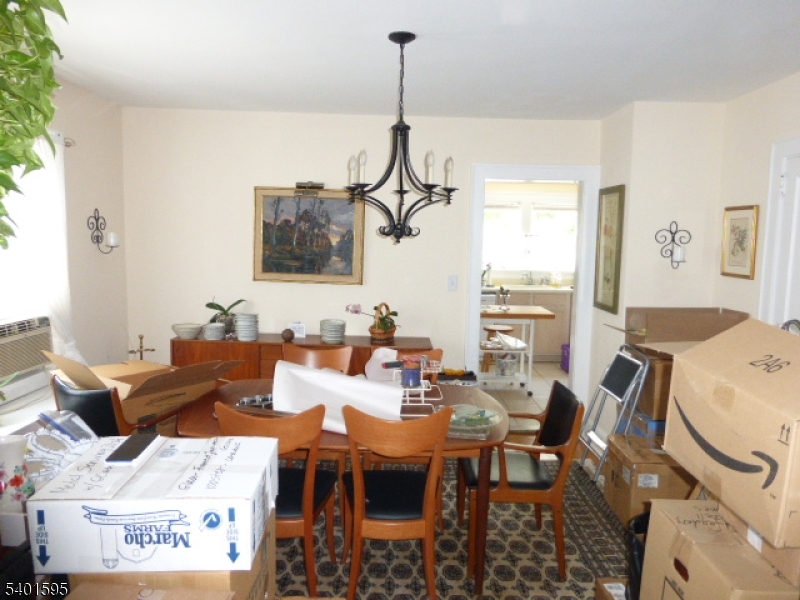 18 Sherman Avenue, Unit B Morris Plains, NJ 07950 - Photo 5 of 24 a living room with furniture a chandelier and a window