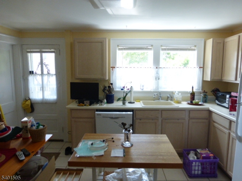 18 Sherman Avenue, Unit B Morris Plains, NJ 07950 - Photo 8 of 24 a kitchen with a sink cabinets and a window