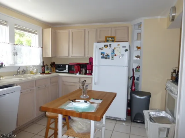 a kitchen with a refrigerator and a stove top oven