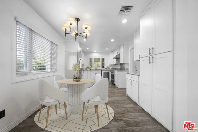 a view of a dining room with furniture and a chandelier