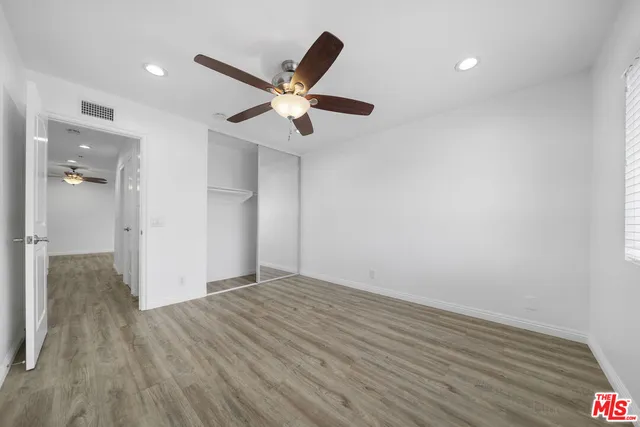 a view of an empty room and wooden floor
