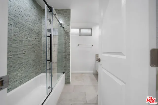a bathroom with a bathtub and a shower