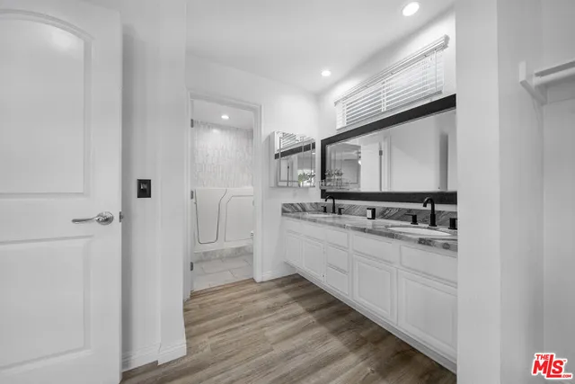 a large white kitchen with a sink