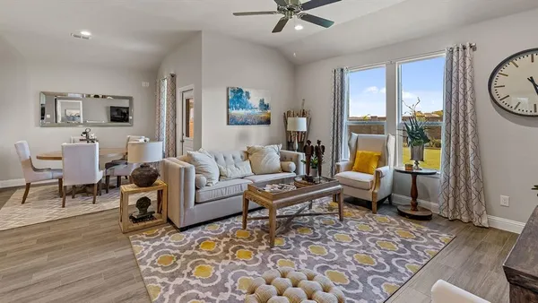 a dining room with furniture and kitchen view